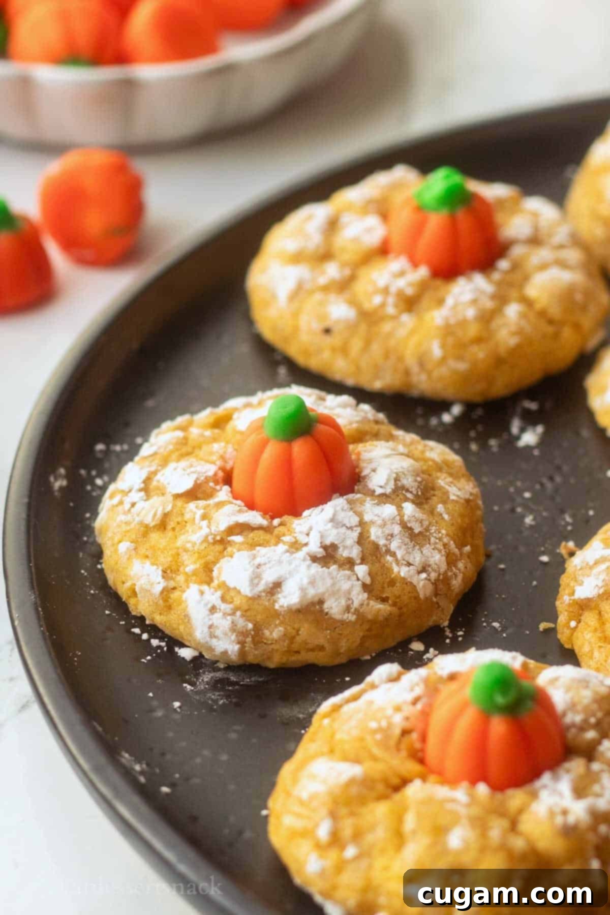 Baked pumpkin sugar cookies on plate, ready to be enjoyed.
