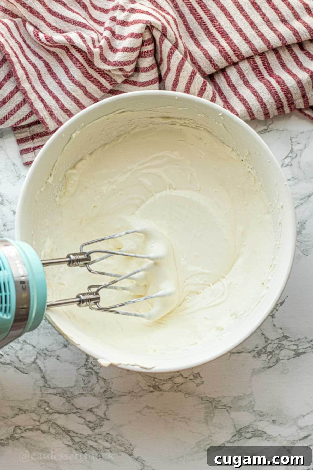 Cloud-Light Cream Cheese Whip 6 The cream cheese and heavy cream mixture being whipped in a bowl.