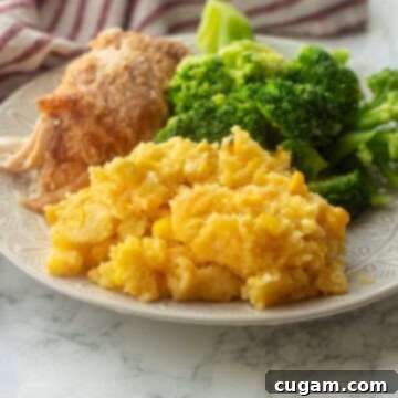 Cooked corn pudding with broccoli and meat on a plate.