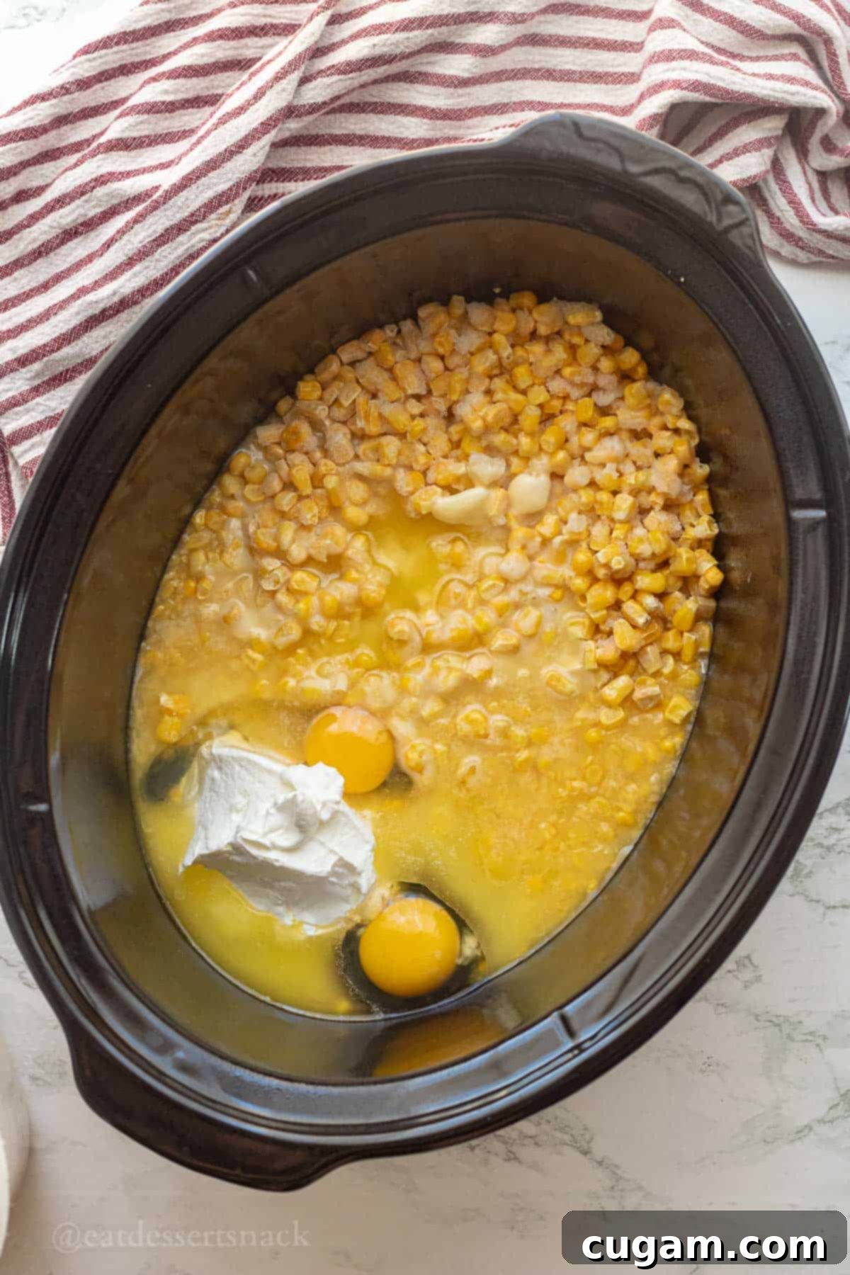 Raw wet ingredients for corn pudding in slow cooker.