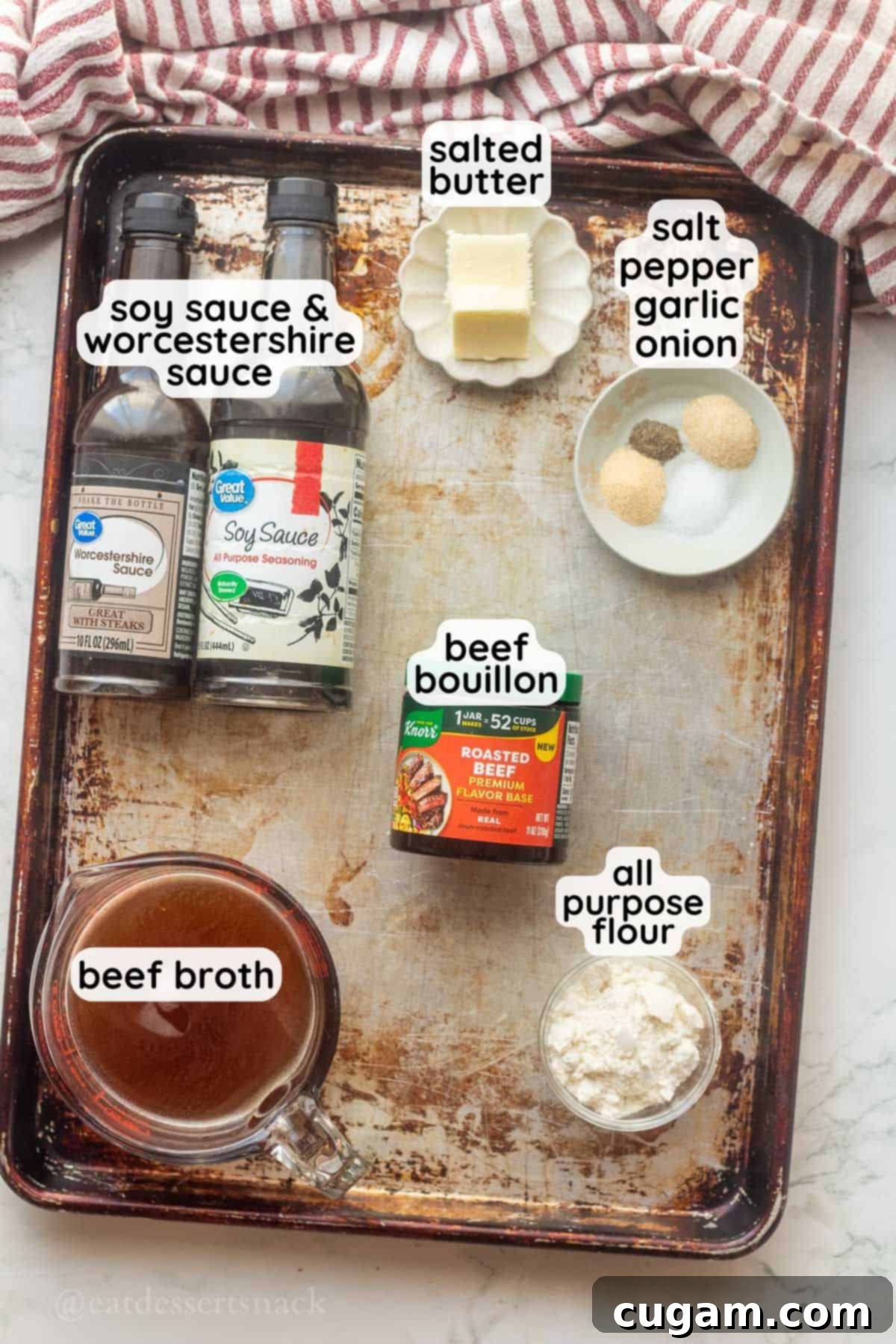 A labeled close-up shot of brown gravy ingredients neatly arranged on a metal pan, showcasing the key components for a flavorful gravy.