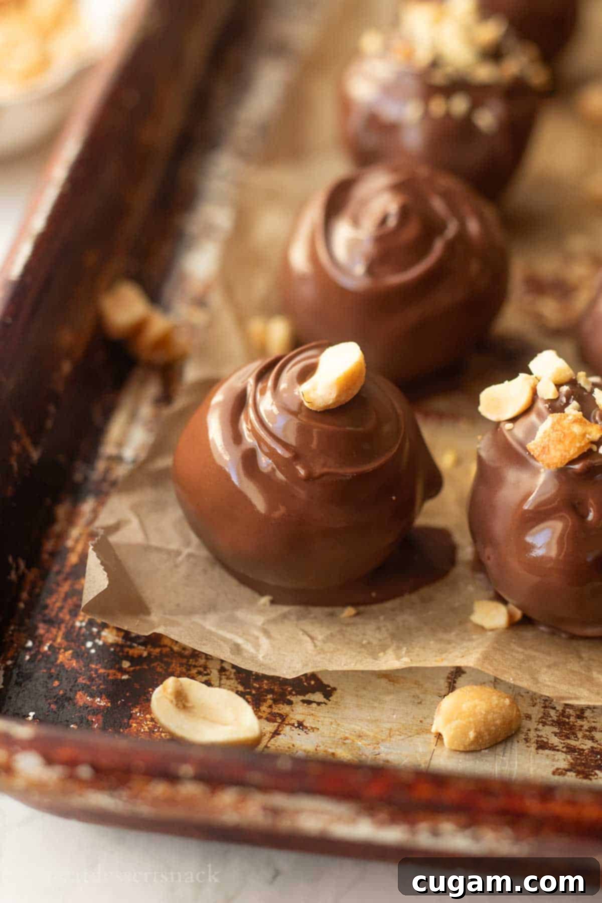 Peanut Butter Rice Crispy Bites 2 Dipped peanut butter ball on baking sheet.