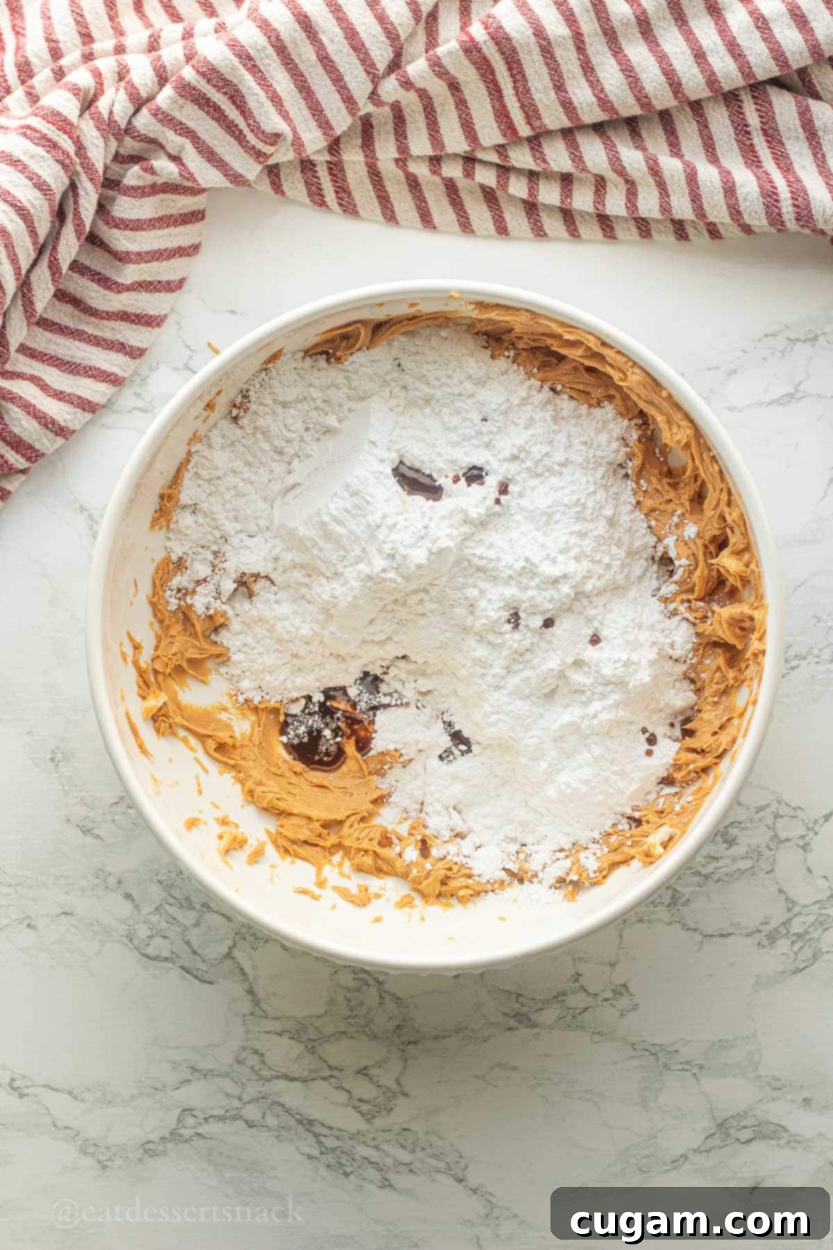 Peanut Butter Rice Crispy Bites 5 Powdered sugar and vanilla in bowl of peanut butter.