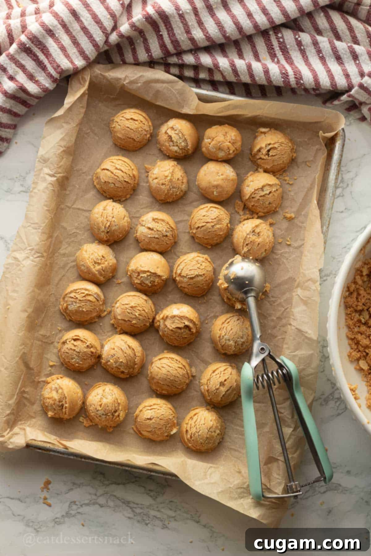 Peanut Butter Rice Crispy Bites 7 Scooped peanut butter balls on tray.