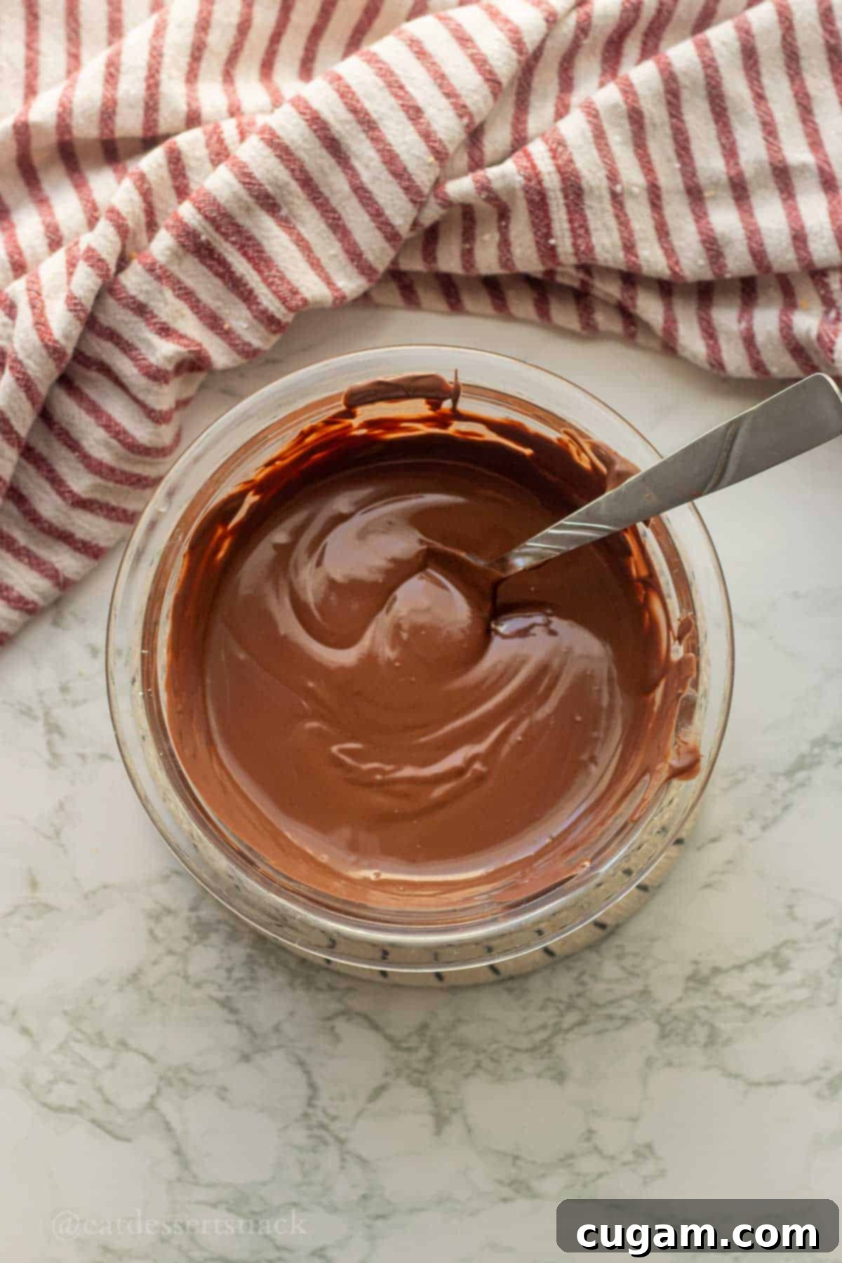 Peanut Butter Rice Crispy Bites 8 Melted chocolate in bowl with spoon.