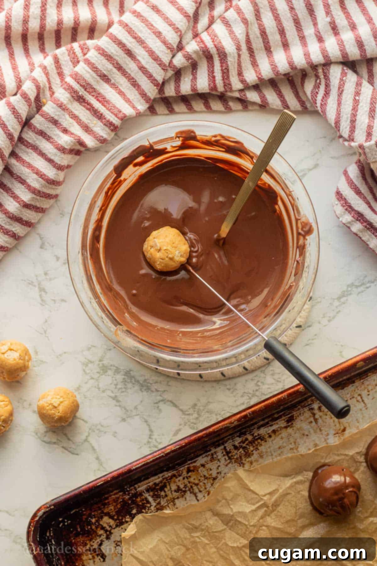 Peanut Butter Rice Crispy Bites 9 Dipping peanut butter balls into bowl of melted chocolate.