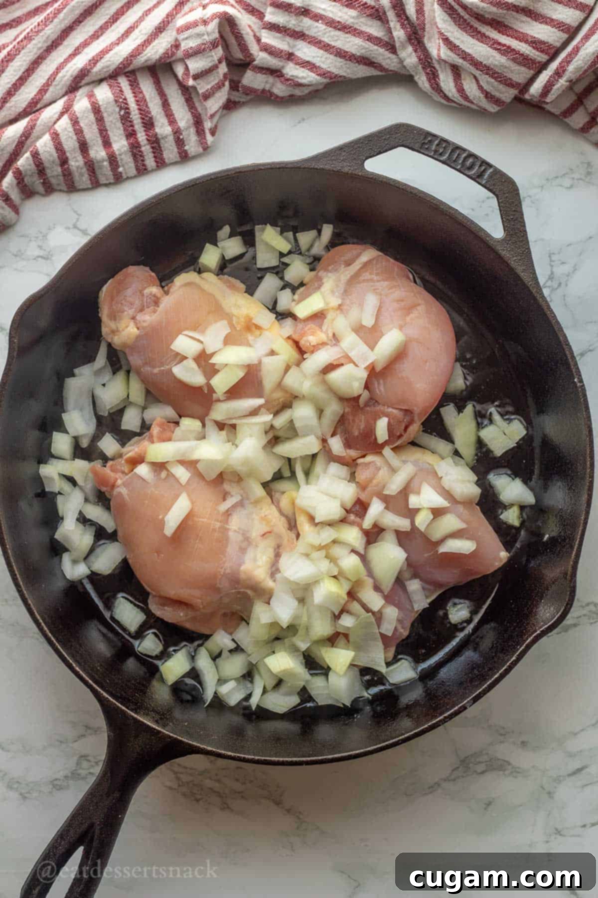 Green Chile Chicken Stew 5 Chicken with chopped onion in pan, cooking.
