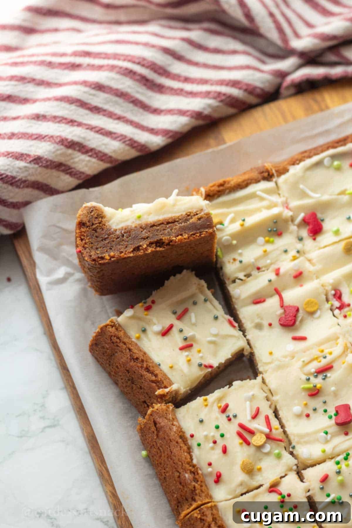 Frosted Gingerbread Squares 11 Beautifully sliced gingerbread bars on parchment paper, ready for serving.