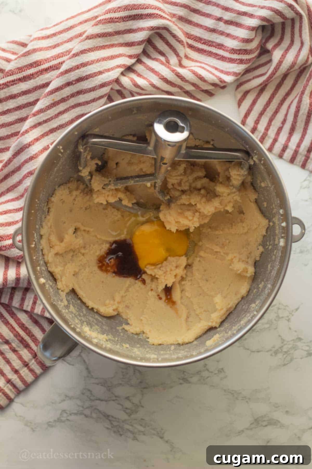 Frosted Gingerbread Squares 5 Eggs and vanilla being added to the creamed butter and sugar mixture.