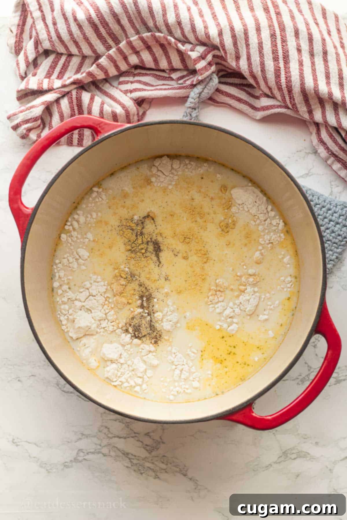 Tomato, White Bean & Tortellini Soup: A Tuscan Twist 4 Flour and seasoning in soup broth in pot.