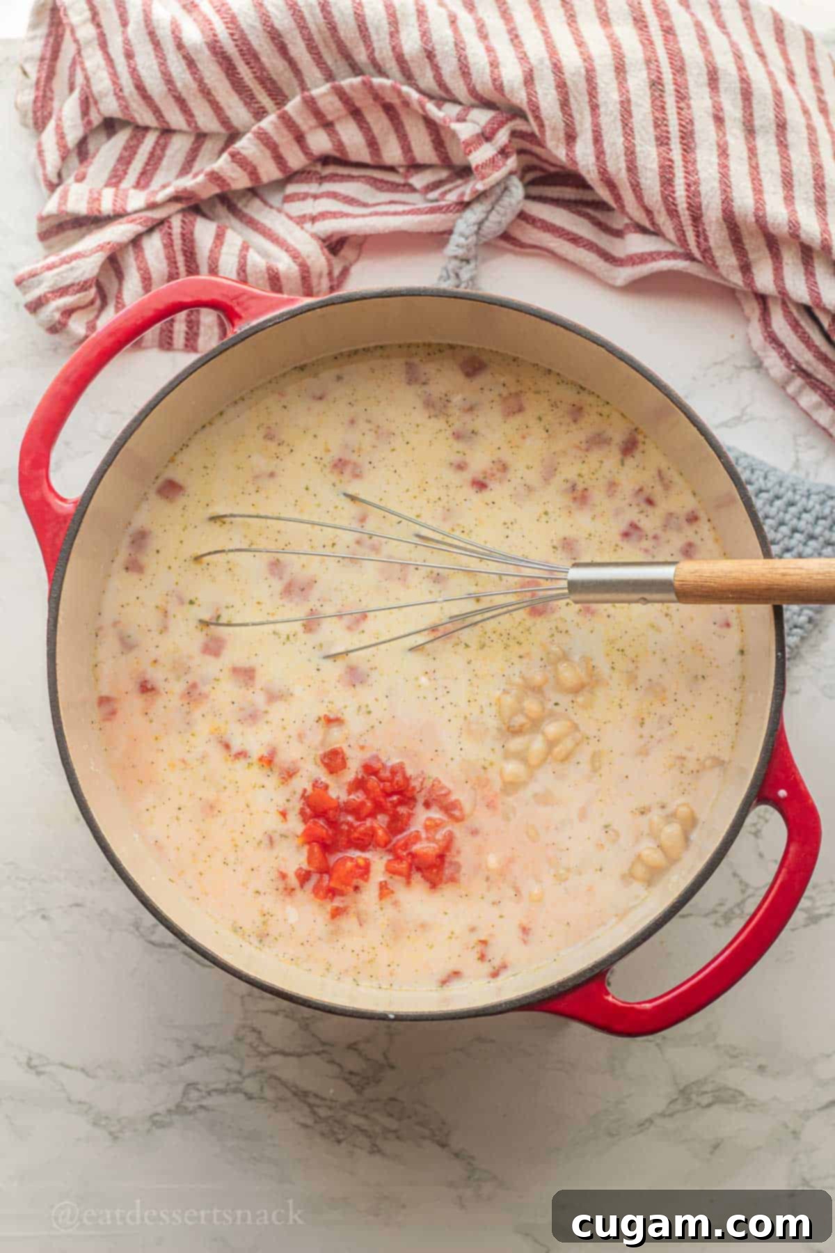 Tomato, White Bean & Tortellini Soup: A Tuscan Twist 5 Tomatoes in soup pot with wooden spoon.