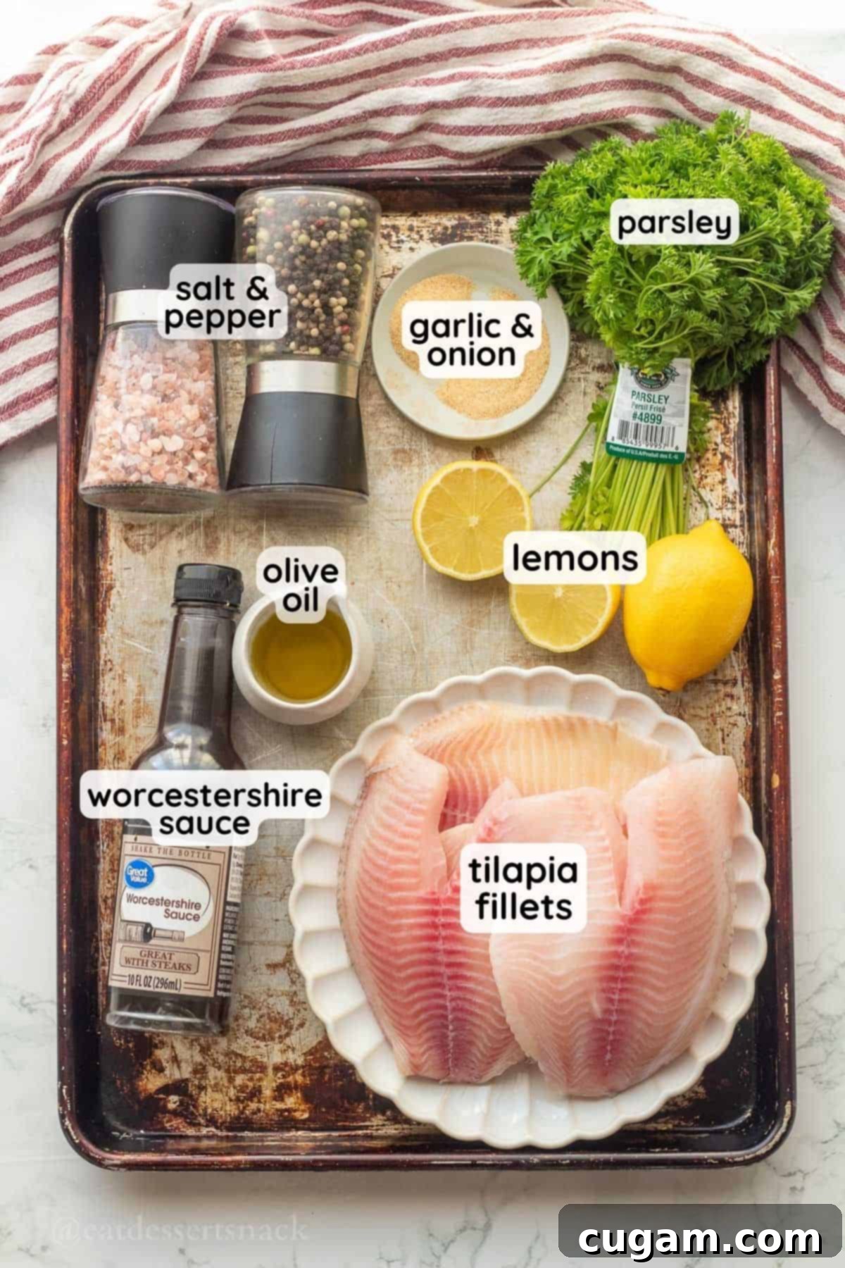 Perfectly Zesty Lemon Pepper Tilapia 3 Ingredients for lemon pepper tilapia, labeled in glass dishes on a metal baking pan.