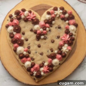 Frosted Heart Cookie Slab 10 Frosted heart shaped cookie cake on wood platter.