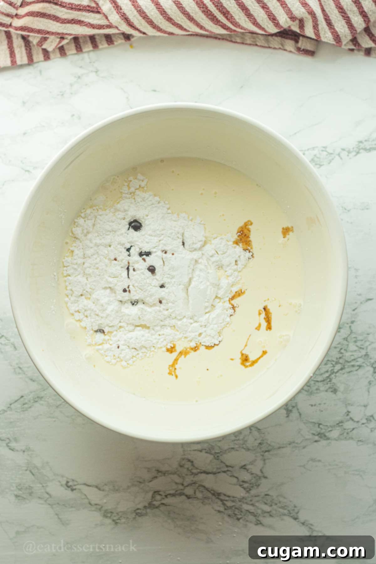 Frog Eye Salad 7 Powdered sugar and vanilla in bowl of cream.