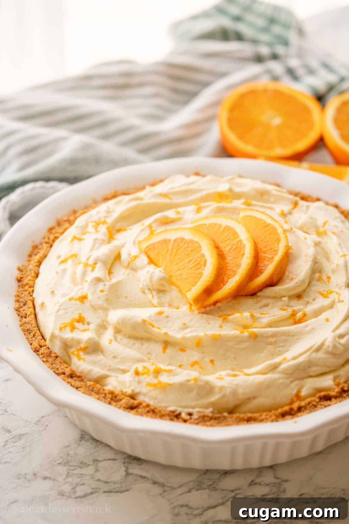 Sunshine Citrus Dream Pie 2 Orange pie with slices on top in pie pan.