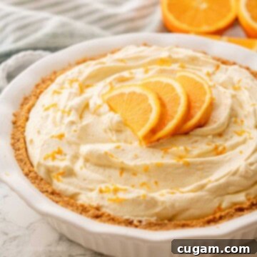 Orange pie with slices on top in pie pan.